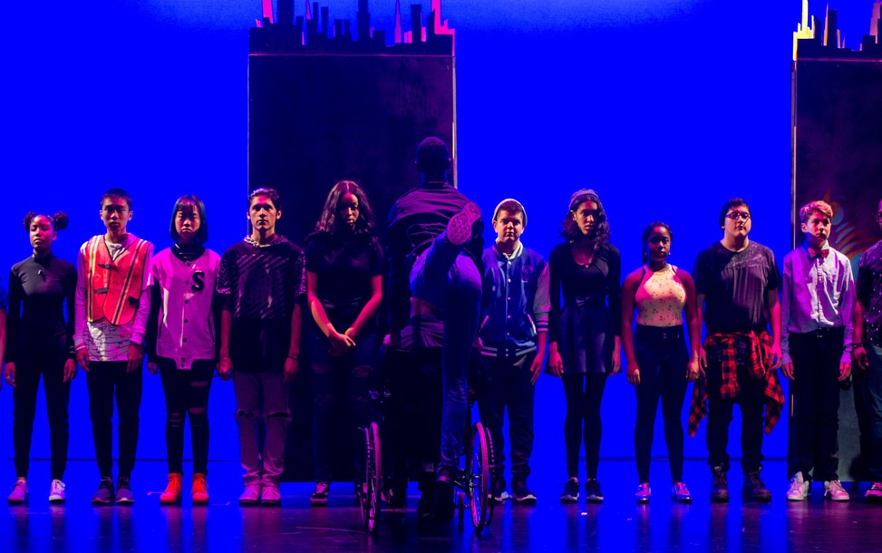 Students standing in a line on a stage
